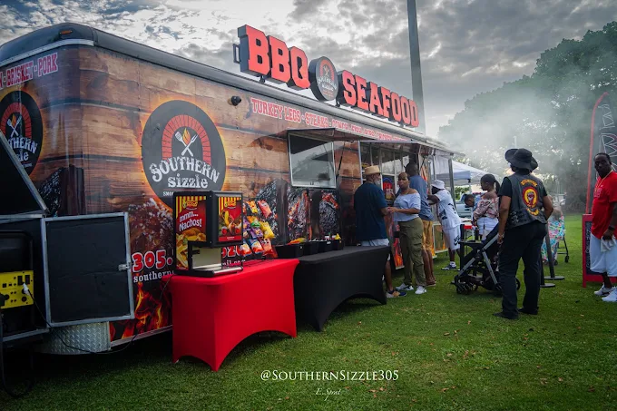 The Southern Sizzle BBQ and Seafood food truck serving customers at an outdoor event